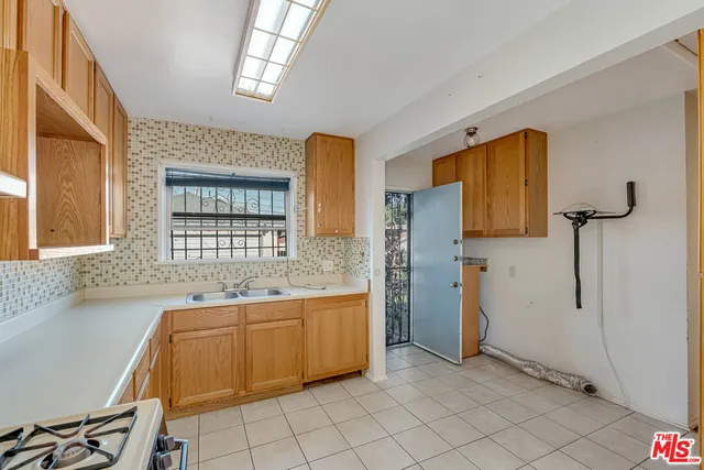 a kitchen with stainless steel appliances granite countertop a stove sink and cabinets