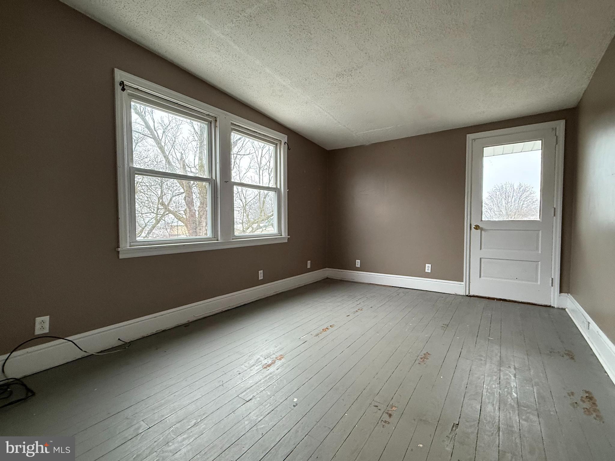 263 West Main Street Dallastown, PA 17313 - Photo 19 of 27 an empty room with wooden floor and windows