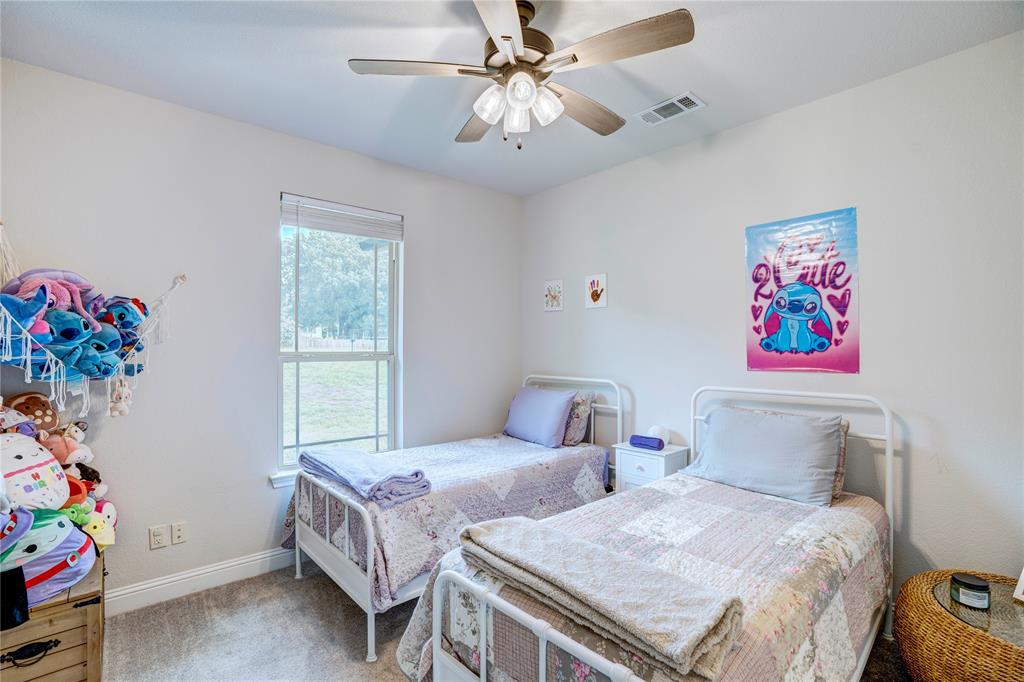 1355 Jay Bird Road Springtown, TX 76082 - Photo 30 of 40 a bedroom with two beds and a window