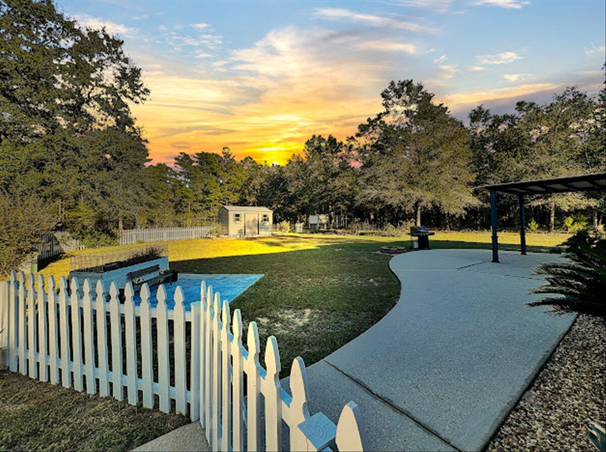 208 Hinote Road DeFuniak Springs, FL 32433 - Photo 2 of 49 a view of a swimming pool with a patio and a yard