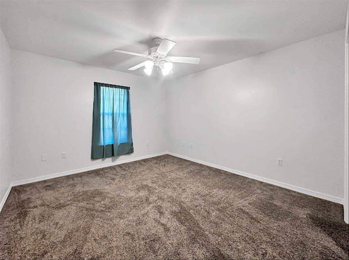 208 Hinote Road DeFuniak Springs, FL 32433 - Photo 32 of 49 an empty room with a window and a fan