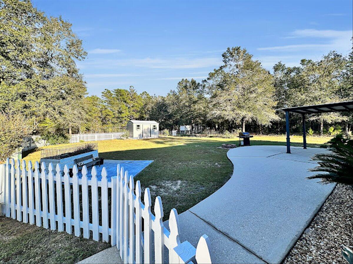 208 Hinote Road DeFuniak Springs, FL 32433 - Photo 37 of 49 a view of a swimming pool with a patio