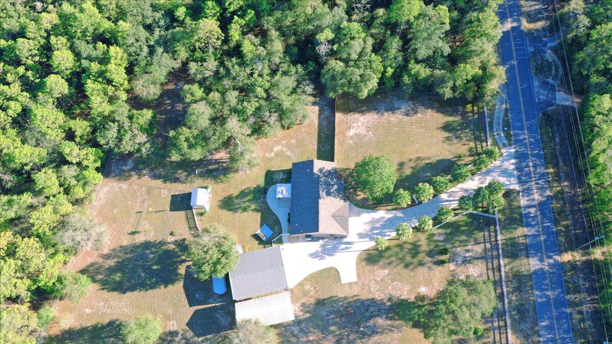 208 Hinote Road DeFuniak Springs, FL 32433 - Photo 4 of 49 a view of a yard with plants and large trees