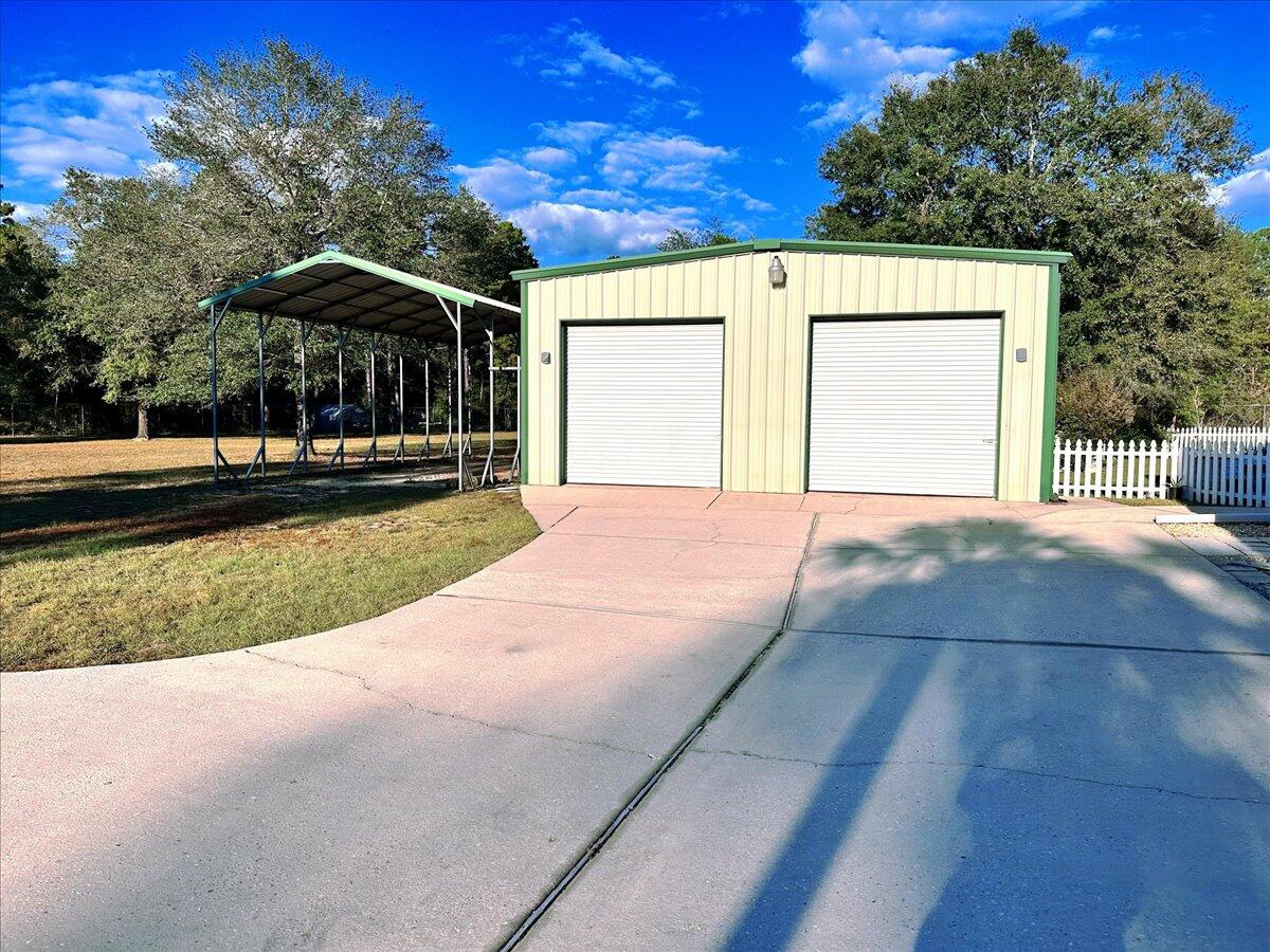 208 Hinote Road DeFuniak Springs, FL 32433 - Photo 42 of 49 a view of a house with backyard and trees