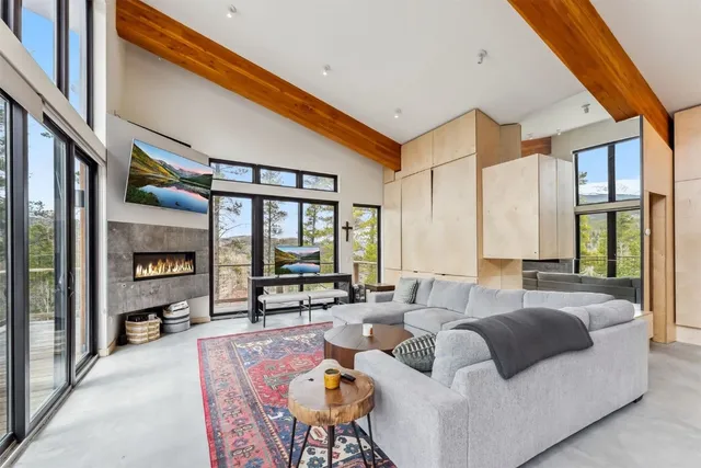 a living room with furniture a rug and a large window