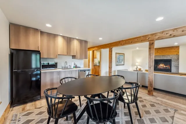 a living room with furniture a large window and a chandelier