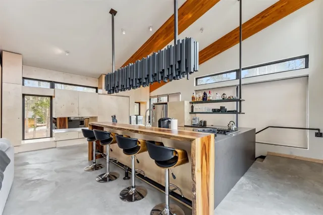 a very nice looking room with a large window and stainless steel appliances