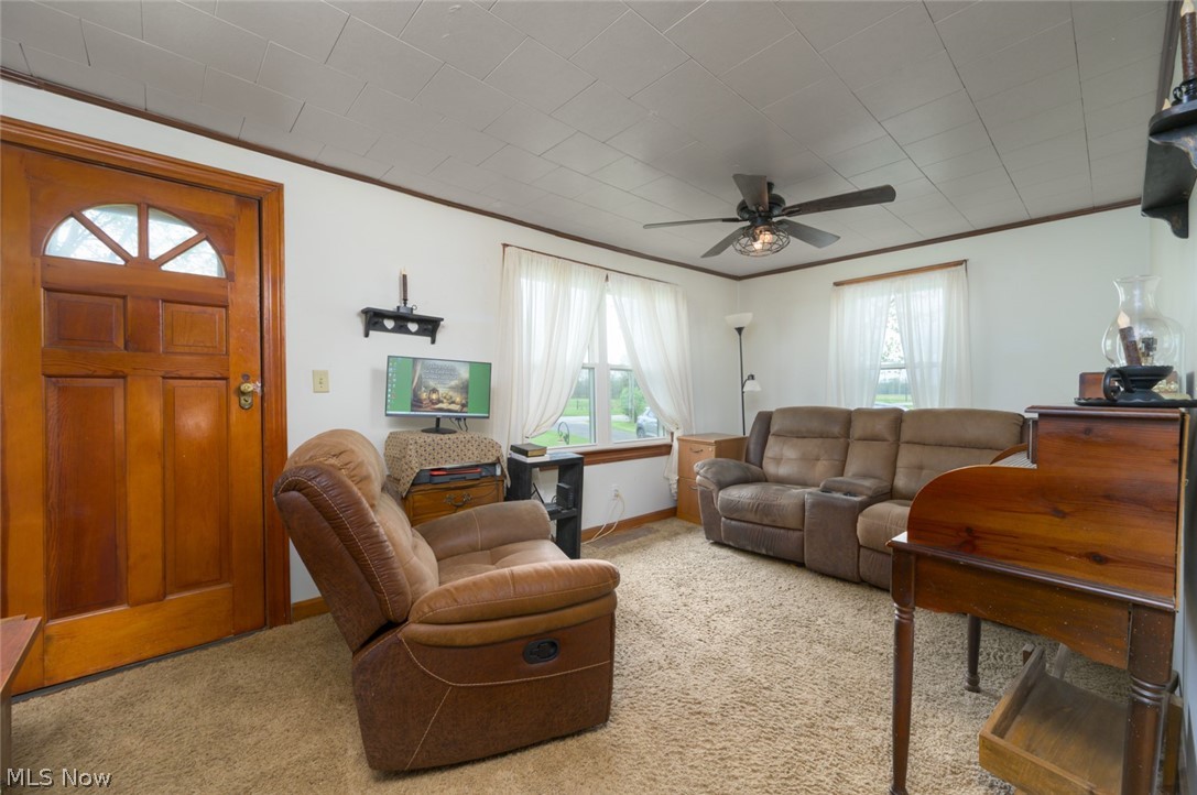 10190 Penniman Road Orwell, OH 44076 - Photo 17 of 24 Neutral wall paint, textured ceiling, a ceiling fan with integrated lighting, and multiple windows with white trim
