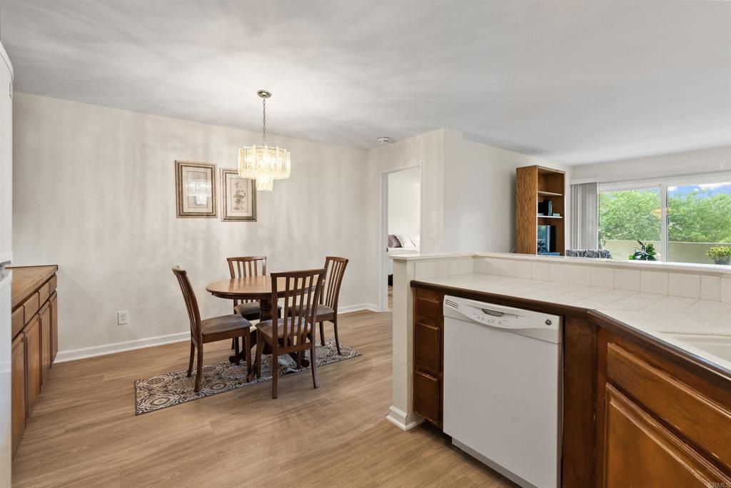 17607 Pomerado Road, Unit 101 San Diego, CA 92128 - Photo 13 of 39 a view of a dining room with furniture window and wooden floor