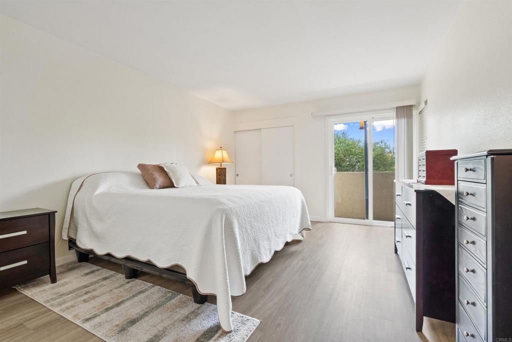 17607 Pomerado Road, Unit 101 San Diego, CA 92128 - Photo 15 of 39 a bedroom with a bed and wooden floor