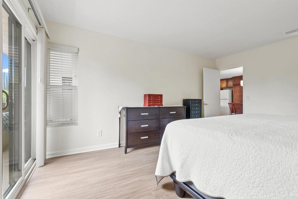 17607 Pomerado Road, Unit 101 San Diego, CA 92128 - Photo 17 of 39 a bedroom with a bed and wooden floor
