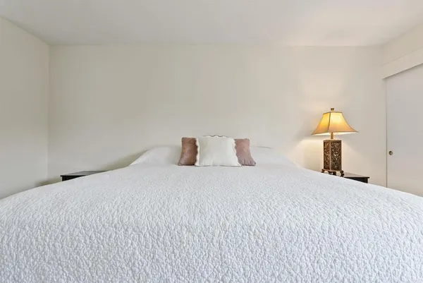 a bedroom with a bed and a night stand