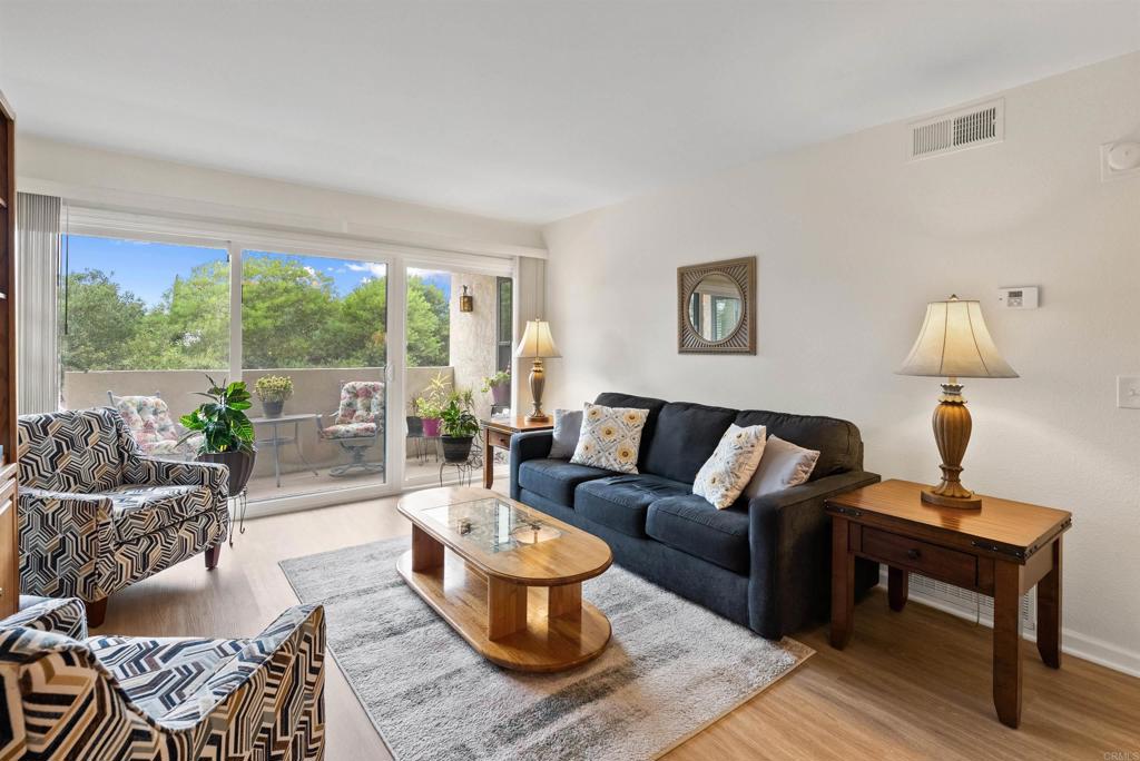 17607 Pomerado Road, Unit 101 San Diego, CA 92128 - Photo 2 of 39 a living room with furniture and a potted plant