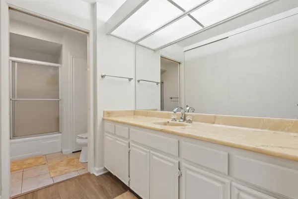 a bathroom with a granite countertop sink and mirror