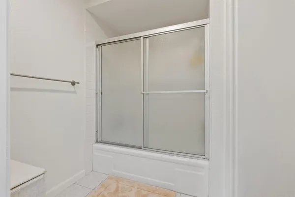 a bathroom with a glass shower door