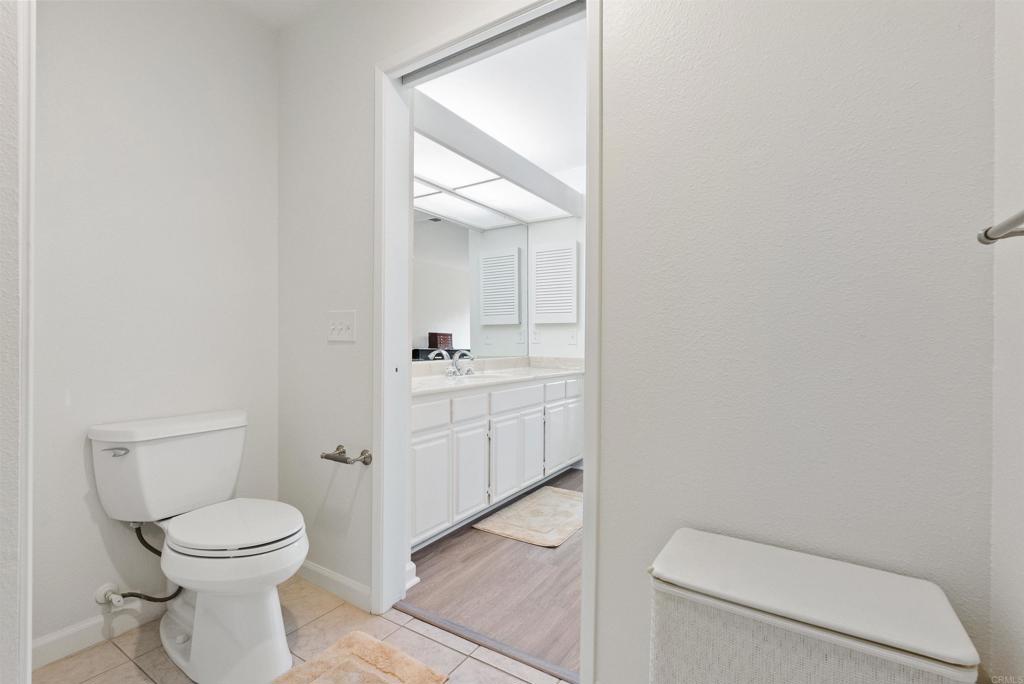 17607 Pomerado Road, Unit 101 San Diego, CA 92128 - Photo 26 of 39 a bathroom with a toilet a sink and a mirror