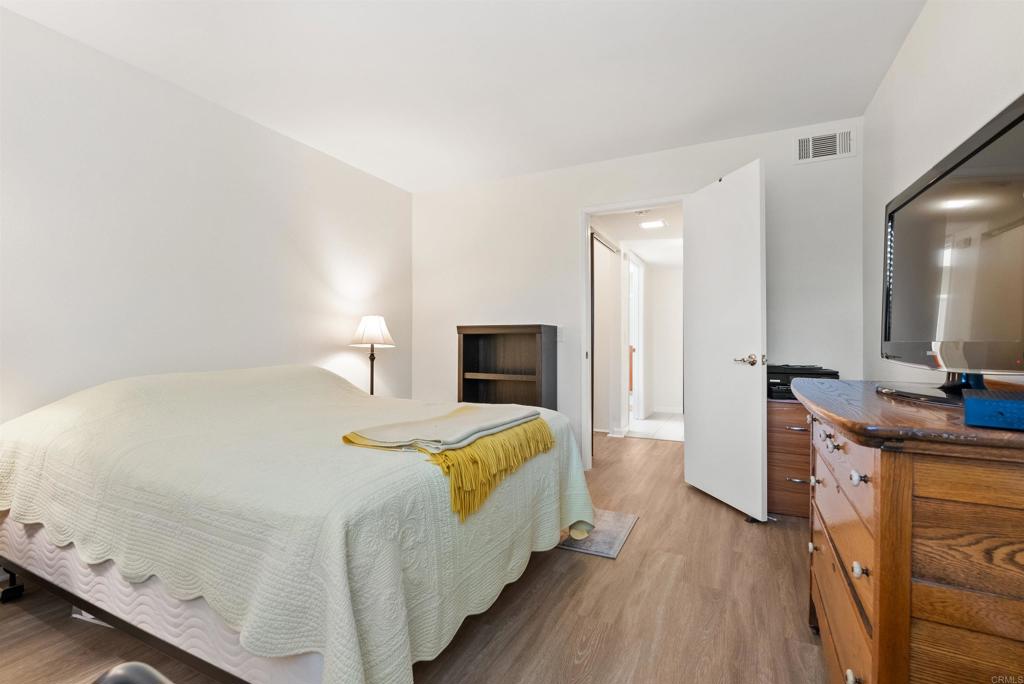 17607 Pomerado Road, Unit 101 San Diego, CA 92128 - Photo 30 of 39 a bedroom with a bed and a flat screen tv