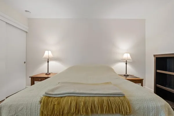 a bedroom with a bed and a lamp