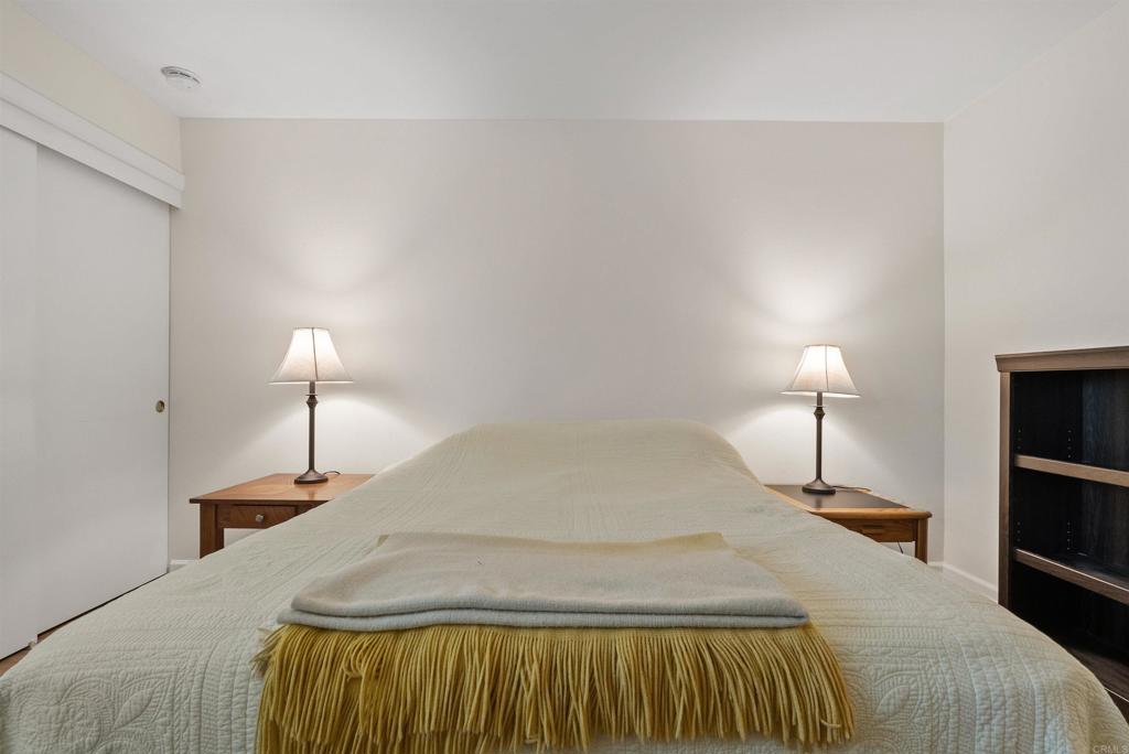 17607 Pomerado Road, Unit 101 San Diego, CA 92128 - Photo 32 of 39 a bedroom with a bed and a lamp