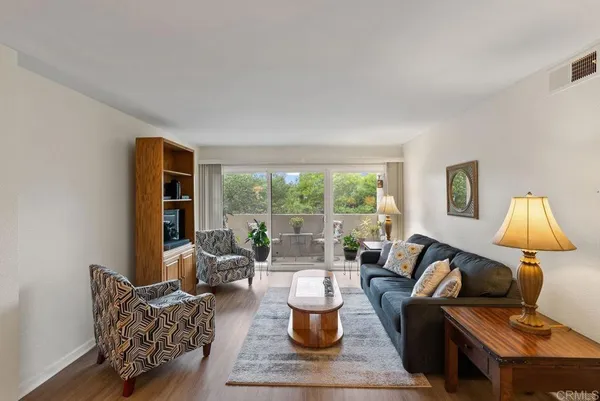 a living room with furniture and a lamp
