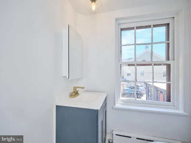 a bathroom with a sink vanity and a mirror