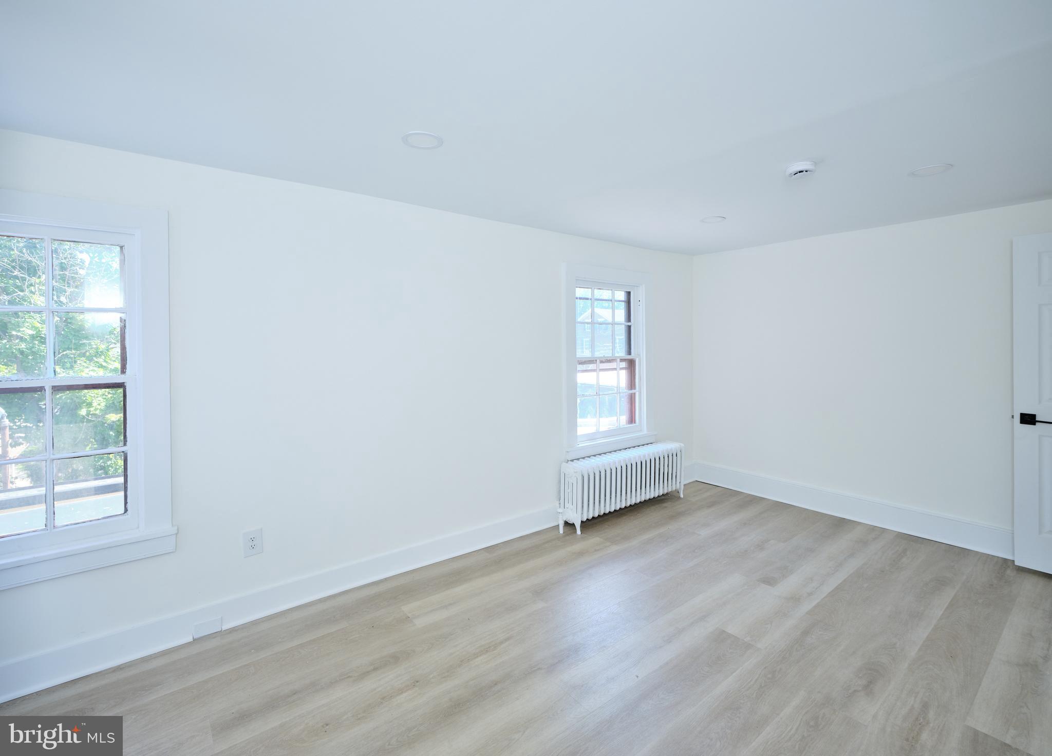 14 West Bridge Street, Unit A New Hope, PA 18938 - Photo 19 of 20 an empty room with wooden floor and windows