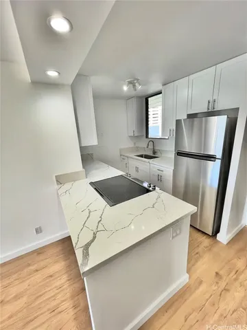 a kitchen with a sink a refrigerator and a stove