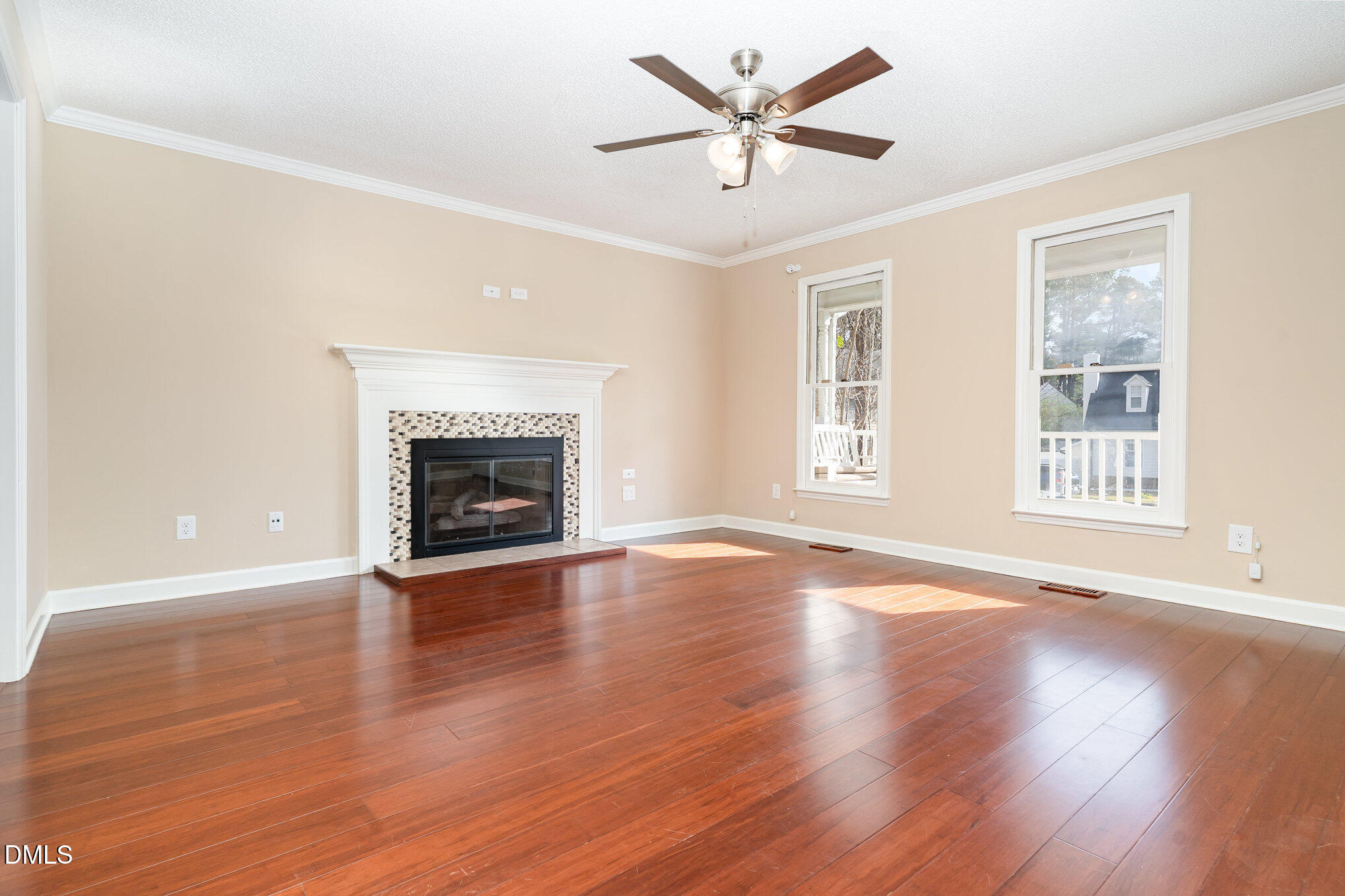 7329 Bassett Hall Court Raleigh, NC 27616 - Photo 7 of 35 a view of an empty room with wooden floor and a window