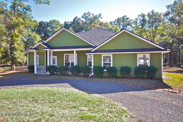 3276 Gay Road Orange Park, FL 32065 - Photo 1 of 21 a front view of a house with a yard and garage