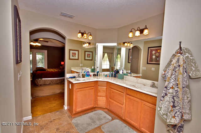 3276 Gay Road Orange Park, FL 32065 - Photo 12 of 21 a spacious bathroom with a granite countertop sink a mirror and shower