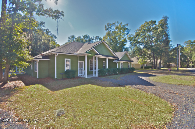 3276 Gay Road Orange Park, FL 32065 - Photo 2 of 21 a front view of a house with a yard and trees