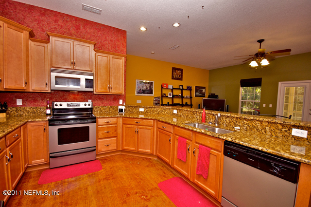 3276 Gay Road Orange Park, FL 32065 - Photo 10 of 21 a kitchen with stainless steel appliances granite countertop a stove sink and cabinets