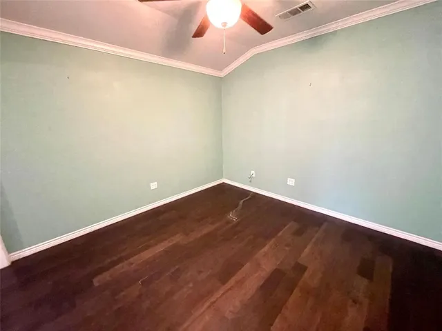en empty room with wooden floor