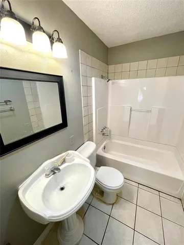 a bathroom with a sink a toilet and bathtub