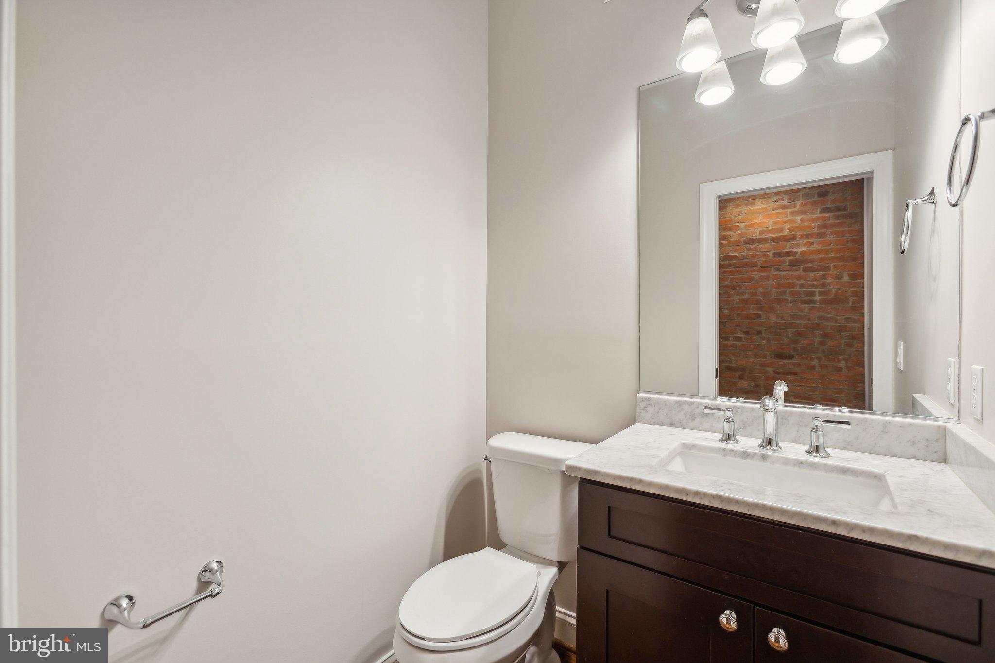 39 U Street Northeast, Unit 1 Washington, DC 20002 - Photo 6 of 22 a bathroom with a toilet a sink and mirror