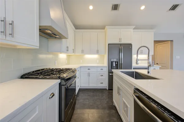 a kitchen with cabinets and appliances