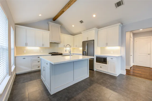a kitchen with cabinets and window