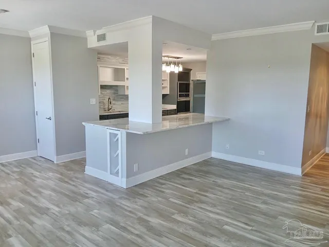 a view of a kitchen cabinets and wooden floor