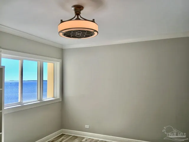 a view of a room with wooden floor and bathroom