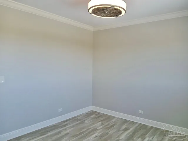 a view of walk in closet with wooden floor
