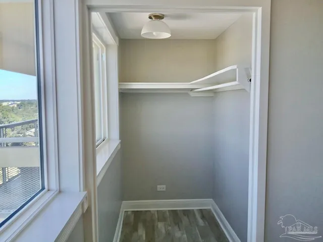 a view of an empty room with wooden floor
