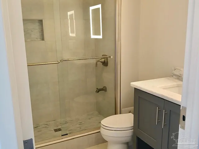 a bathroom with a sink toilet and shower