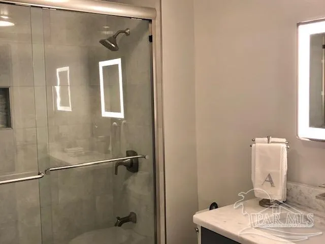 a bathroom with a shower and a sink