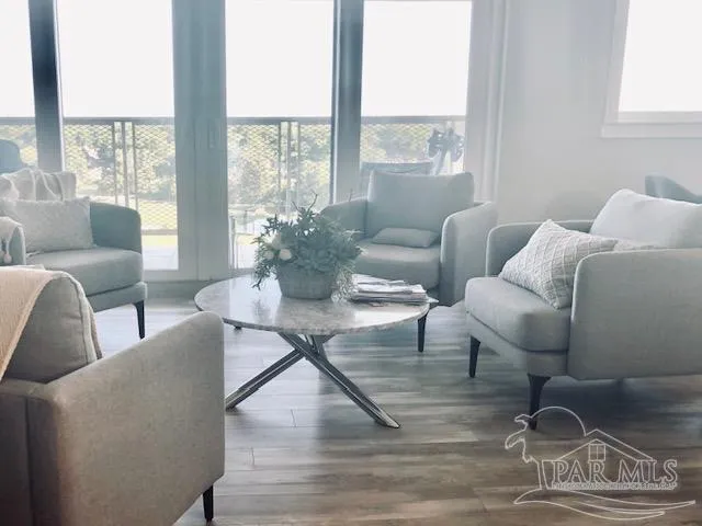a living room with furniture and a floor to ceiling window
