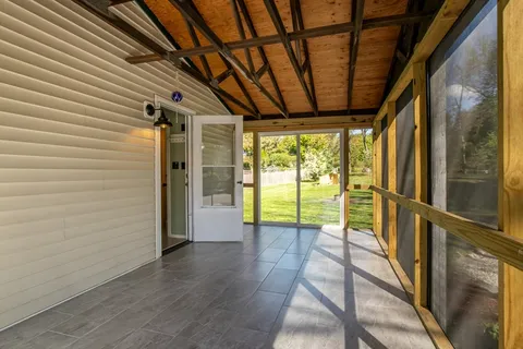 a view of hallway with wooden floor