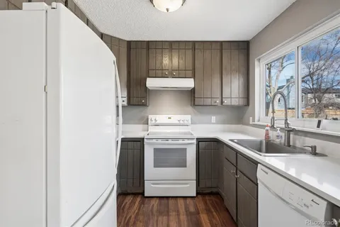 a kitchen with a sink cabinets and wooden floor