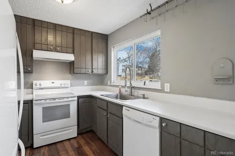 a kitchen with a sink stove and cabinets