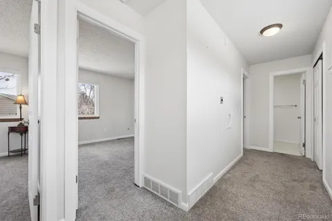 an empty room with windows and closet