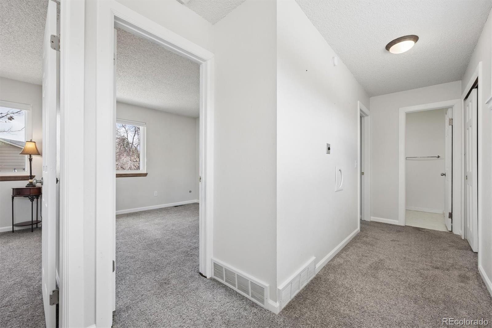 9802 Garrison Court Westminster, CO 80021 - Photo 18 of 34 an empty room with windows and closet