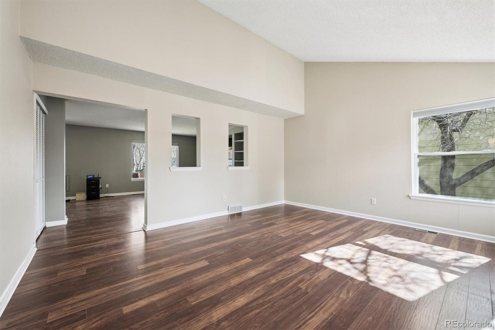 9802 Garrison Court Westminster, CO 80021 - Photo 2 of 34 a view of empty room with wooden floor and fan